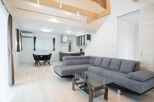 a living room with a couch and a table at Comfy Resort Villa Onna in Onna