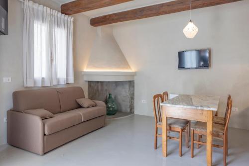 a living room with a couch and a table at Donna Rina - suggestiva casa nel centro storico in Colledimezzo