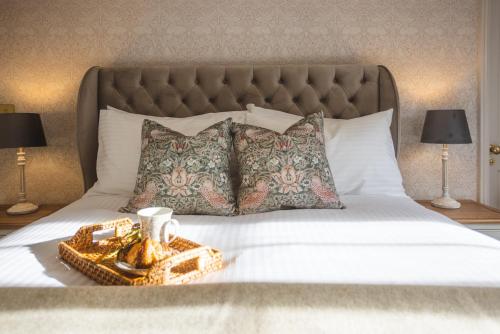 a bed with a gold tray on top of it at Historic City Centre Town House in Chester