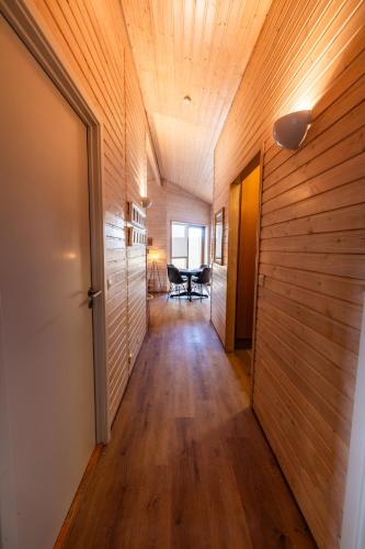 a hallway of a house with wooden walls and a wooden floor at Efsti-Dalur Cottages in Úthlid
