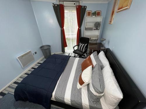 a bedroom with a bed and a chair in it at Quayside Deluxe Double Room in Colchester