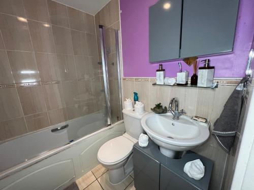 a bathroom with a white toilet and a sink at Quayside Deluxe Double Room in Colchester