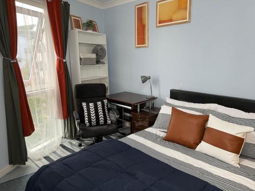 a bedroom with a bed and a desk and a chair at Quayside Deluxe Double Room in Colchester