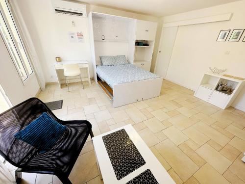 a small room with a bed and a chair at Nice House Rent in Saint-Laurent-du-Var