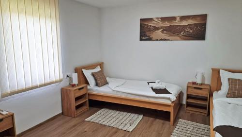 Postel nebo postele na pokoji v ubytování Apartmani - Kladovski Konak
