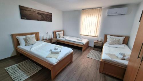 a room with two beds and a couch at Apartmani - Kladovski Konak in Kladovo