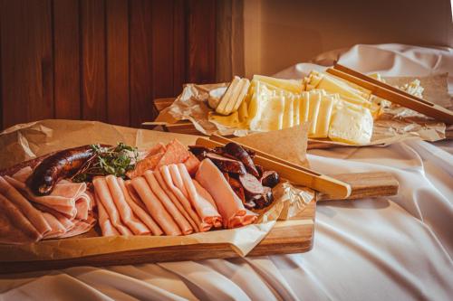 a tray of different types of food on a bed at Hotel Sepetná in Ostravice