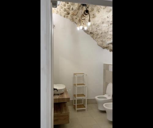 a bathroom with a toilet and a sink at Arcaroli Borgo Vico "Luxe" in Vico del Gargano