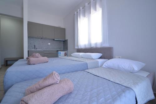 a bedroom with two beds with towels on them at Villa Matina in Leptokarya