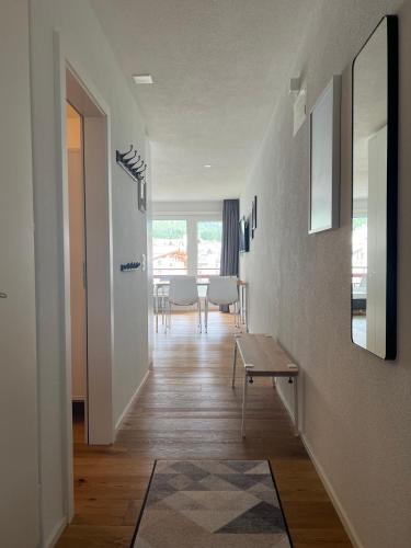 a hallway with a table and a dining room at Ferienwohnung 405 Haus Allod in Lenzerheide