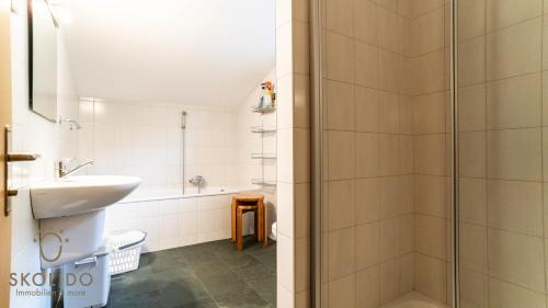 a bathroom with a shower and a sink at Haus Cotton 4.5 Room Apartment in Breiten