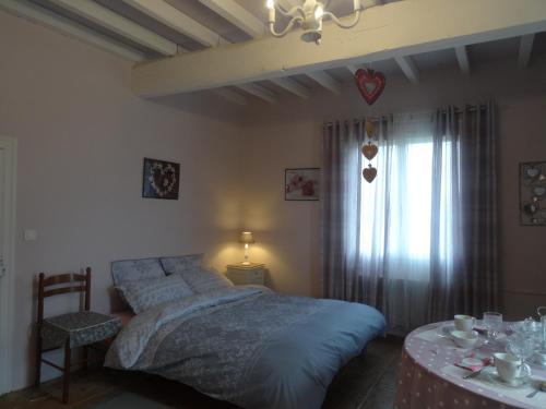 a bedroom with a bed and a table and a window at chambre 4 personnes in Montain