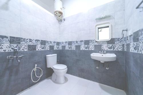 a bathroom with a toilet and a sink at KBS Sree Paradise Kodai in Kodaikānāl