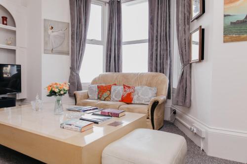 a living room with a couch and a coffee table at Sherwood Hotel in Margate