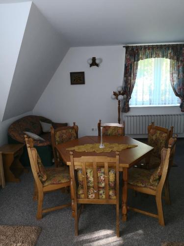 a dining room with a table and chairs at Noclegi Hexe in Żegocina