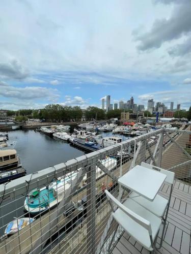 a balcony with a view of a marina with boats at 2BD Flat with Views of Canary Wharf - Rotherhithe in London