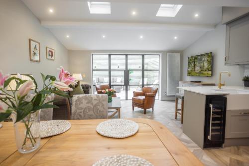 a kitchen and living room with a table and a living room at Historic City Centre Town House in Chester