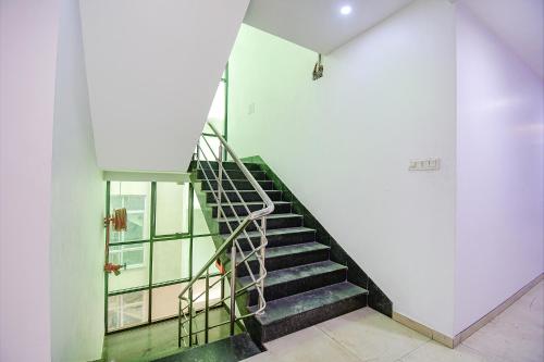 a staircase in a building with a stair case at FabHotel Rani Tower - Chinar Park in Kolkata