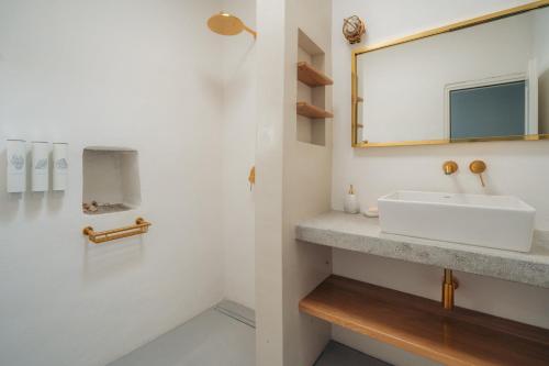 a bathroom with a sink and a mirror at Eco-Luxe Retreat in Ano Petali, Sifnos in Apollonia