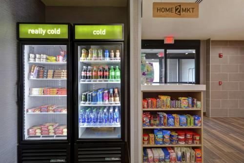 two refrigerators in a store with drinks and food at Home2 Suites By Hilton Dayton South in Miamisburg