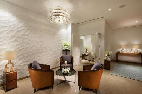 a lobby with chairs and a table and a chandelier at Hilton Clark Sun Valley Resort in Clark