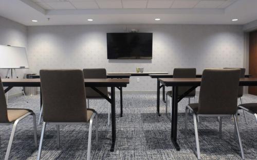 a conference room with tables and chairs and a flat screen tv at Hampton Inn Camden, SC in Camden