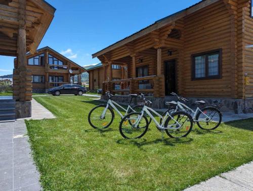 a group of bikes parked outside of a log cabin at LOG HOUSE in Bakuriani
