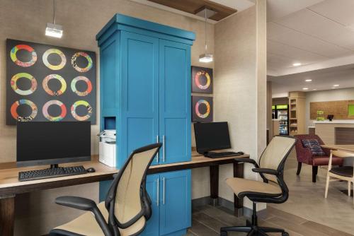 an office with a blue cabinet and a desk with a computer at Home2 Suites By Hilton Madison Central Alliant Energy Center in Madison