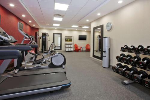 a fitness room with a treadmill and weights at Home2 Suites By Hilton West Bloomfield, Mi in North Farmington