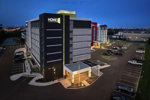 a large building with a sign on it in a parking lot at Home2 Suites By Hilton Toronto/Brampton, On in Brampton