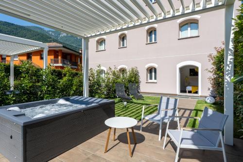 a hot tub on the patio of a house at Bianco Hotel in Primaluna