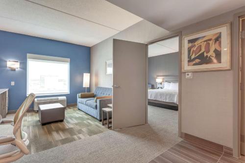 a hotel room with a bed and a couch at Home2 Suites By Hilton Toronto/Brampton, On in Brampton