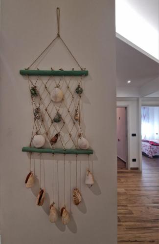 a shelf with shells hanging on a wall at Appartamento LIBERTA, Liguria in Rapallo