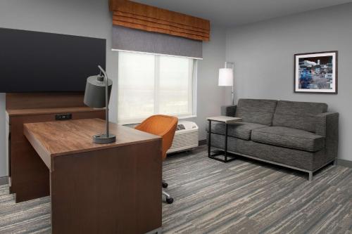 a living room with a couch and a chair at Hampton Inn & Suites Rapid City Rushmore, SD in Rapid City