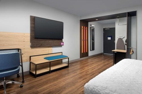 a hotel room with a bed and a desk and a tv at Tru By Hilton Rapid City Rushmore, Sd in Rapid City