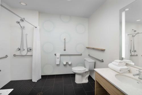 a bathroom with a toilet and a sink at Tru By Hilton Rapid City Rushmore, Sd in Rapid City
