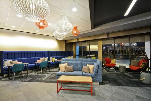 a lobby with a couch and chairs and tables at Tru By Hilton Huber Heights Dayton in Huber Heights