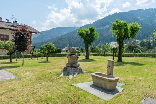ジアーノ・ディ・フィエンメにあるSuàn Hotelの山を背景にした公園にあるクマの像