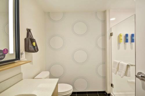 a bathroom with a toilet and a shower at Tru By Hilton Huber Heights Dayton in Huber Heights