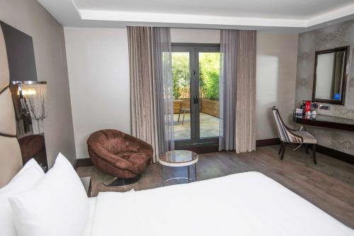 a hotel room with a bed and a chair at DoubleTree by Hilton Istanbul Gayrettepe in Istanbul