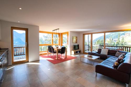 a living room with a couch and a table at Haus Bella Vista in Riederalp
