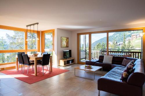 ein Wohnzimmer mit einem Sofa und einem Tisch in der Unterkunft Apartment Bella Vista in Riederalp