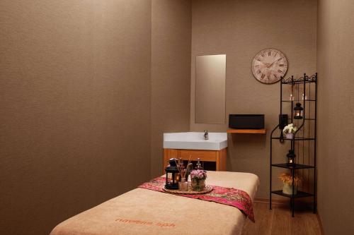 a room with a bed and a clock on the wall at DoubleTree by Hilton Istanbul Gayrettepe in Istanbul