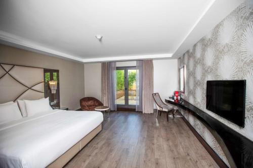 a hotel room with a bed and a television at DoubleTree by Hilton Istanbul Gayrettepe in Istanbul