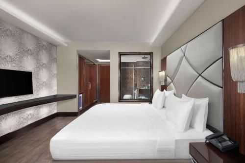 a bedroom with a large white bed and a window at DoubleTree by Hilton Istanbul Gayrettepe in Istanbul