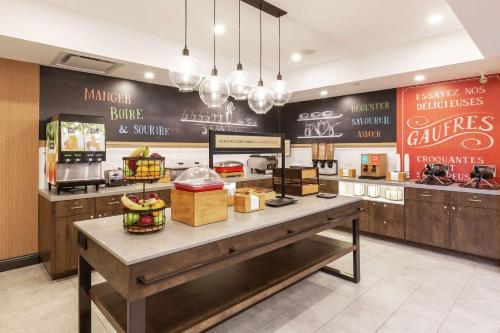 a fast food restaurant with a counter with food at Hampton Inn & Suites by Hilton Québec - Beauport in Quebec City