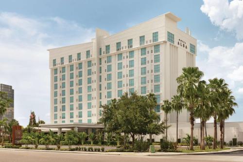 a large white building with trees in front of it at Hotel Alba Tampa, Tapestry Collection By Hilton in Tampa