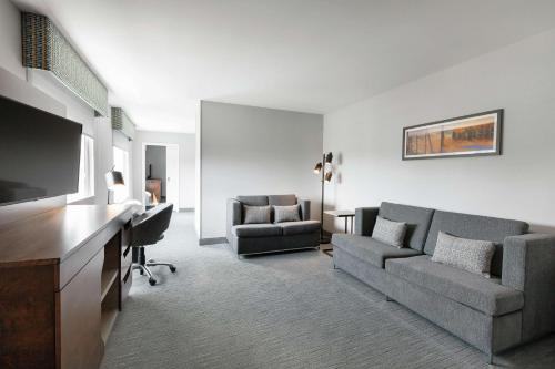 a living room with a couch and a flat screen tv at Hampton Inn & Suites by Hilton Québec - Beauport in Quebec City