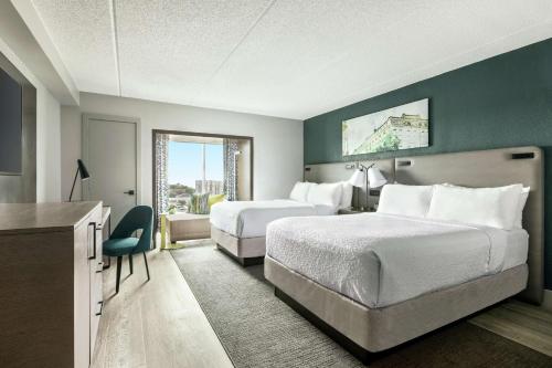 a hotel room with two beds and a window at Hotel Alba Tampa, Tapestry Collection By Hilton in Tampa