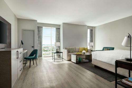 a bedroom with a bed and a living room at Hotel Alba Tampa, Tapestry Collection By Hilton in Tampa